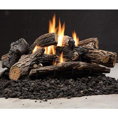 an outdoor fire pit with logs and rocks