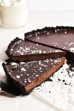 a chocolate tart pie with one slice cut out and the rest on top of it