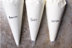 four cones with cream on them that say suss