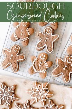 gingerbread cookies with white icing on a cooling rack and in the foreground are snowflakes