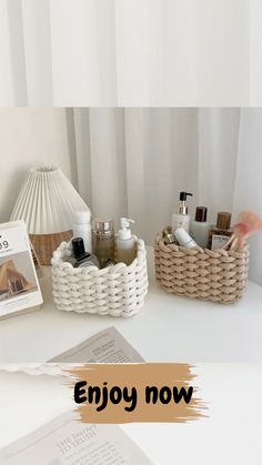 a white table topped with two baskets filled with personal care items next to a book