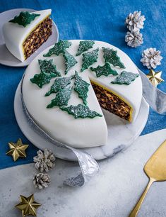 a white cake with green decorations on it