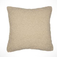 a beige pillow on a white background