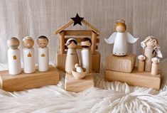 wooden nativity figurines on display in front of a white furnishing