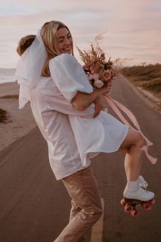 a man riding on the back of a skateboard next to a woman in a white dress