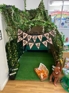 an indoor play area with fake trees and plants on the walls, including a teddy bear