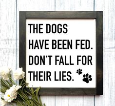 a sign that says the dogs have been fed don't fall for their lies