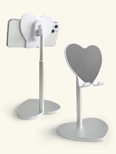 an iphone holder with a heart shaped phone on it and a stand that is attached to it