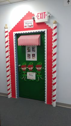 the grinch door is decorated with candy canes and elf hats for an office christmas party