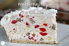 a close up of a piece of cake on a plate with strawberries and nuts