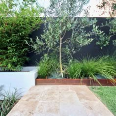 a wooden table sitting in the middle of a garden