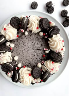 an oreo cookie cake with white frosting and peppermint sprinkles