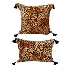 two leopard print pillows with tassels and pom poms on the sides