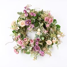 a wreath with pink and white flowers on it