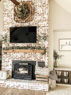 a living room with a brick fireplace and flat screen tv mounted on the mantel