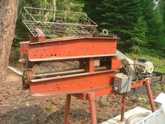 an old machine is sitting in the woods