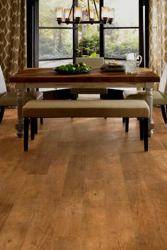 a dining room table with chairs and a bench