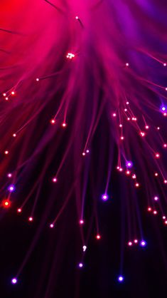 colorful fireworks are lit up in the night sky with red, purple and blue lights