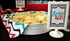 a bowl of chips sitting on top of a table next to a sign that says butter packs