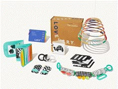 an assortment of craft supplies including scissors, paper clips and magnets in a cardboard box