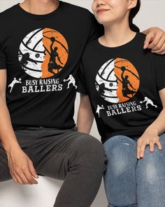 two people sitting next to each other wearing t - shirts with the words busy raising ballers on them