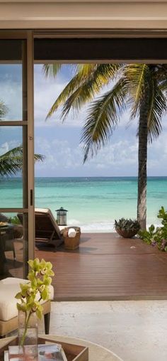 an open door leading to the beach and ocean