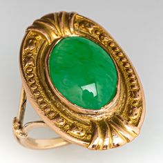 This awesome vintage ring features engraved floral details and contains one (1) oval cabochon cut natural jadeite jade set into a bezel. The ring measures 19.8mm at the top, rises 3.5mm above the finger, tapering to 1.2mm wide and 1.1mm thick at the base of the shank. This ring is currently a size 2.5 and can be sized up. Vintage Green Signet Ring With Polished Finish, Heirloom Jade Jewelry For Formal Occasions, Fine Jewelry Carved Oval Ring, Antique Green Emerald Ring With Polished Finish, Classic Oval Engraved Emerald Ring, Vintage Oval Carved Engraved Ring, Green Oval Signet Ring Collectible, Oval Cabochon Engraved Collectible Ring, Antique Oval Cabochon Emerald Ring