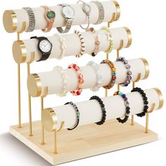 a wooden stand with several bracelets and watches on it's sides, all in different colors