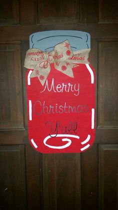 a christmas mason jar door hanger on a wooden door