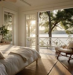 a bedroom with a large bed sitting on top of a hard wood floor next to a window