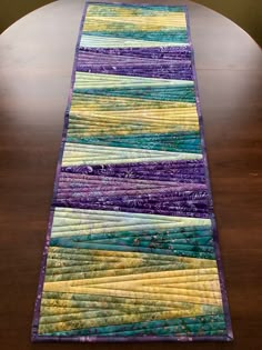 a table runner made out of strips of fabric