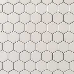 the white hexagonal tiles are arranged in rows