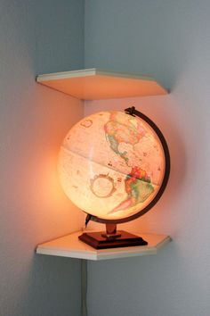 an illuminated globe sitting on top of a shelf