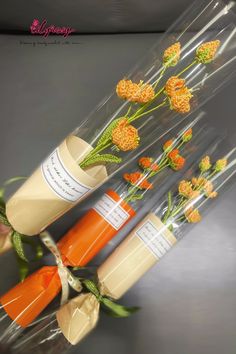 three tubes with flowers in them sitting next to each other