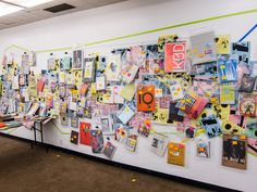 the wall is covered with many different pieces of paper and magnets, including pictures