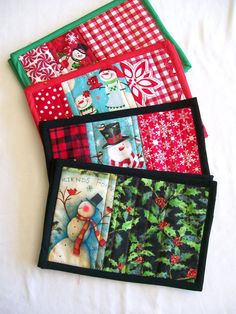 four quilted placemats with snowmen and christmas decorations