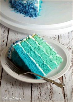 a slice of blue cake on a plate with a fork