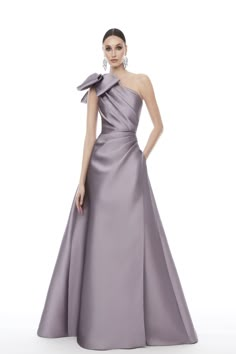 This beautiful one-shoulder A-Line dress offers an effortlessly glam silhouette. It is crafted from a luxurious silk material that skims over the figure and is drenched in a rich hue. The dress features a bow at the waistline, a zip back closure, ruched detailing and a full-length silhouette. This special occasion dres Luxury Purple Tie For Formal Occasions, Mob Dresses, One Shoulder Gown, Sleeveless Gown, فستان سهرة, Evening Dresses Elegant, Stunning Dresses, Full Skirt, Dress With Bow