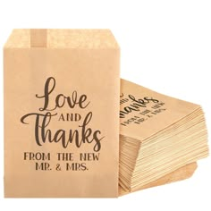 brown paper bags with love and thanks printed on the front are stacked next to each other