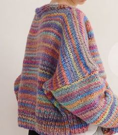 a woman wearing a multicolored knit sweater