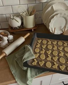 cookies on a cookie sheet with baking utensils next to it and other kitchen items