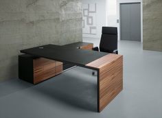 an office desk with two black chairs and a wooden cabinet in front of a concrete wall