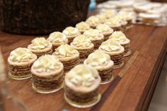 cupcakes are lined up on a wooden table