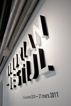 the wall is decorated with black and white letters