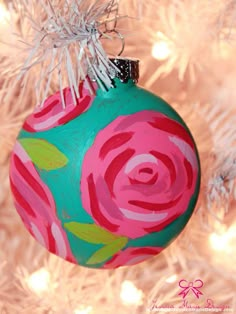 a painted ornament hanging from a christmas tree