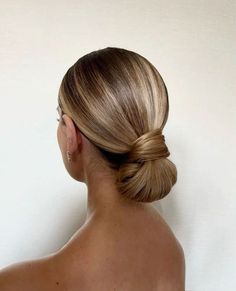 a woman with her hair in a low bun