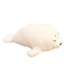 a white stuffed seal animal laying on its side