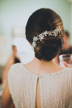 a woman in a white dress wearing a hair comb