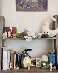 a book shelf filled with books and stuffed animals