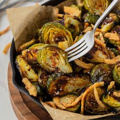 a skillet filled with cooked brussel sprouts and onion rings